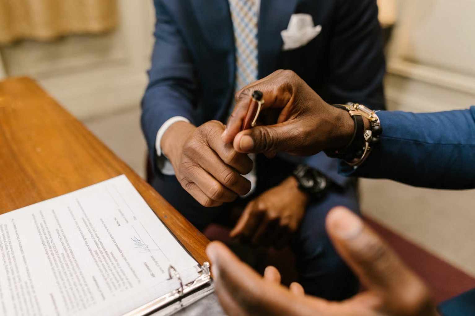 Handing over a pen to sign company documents